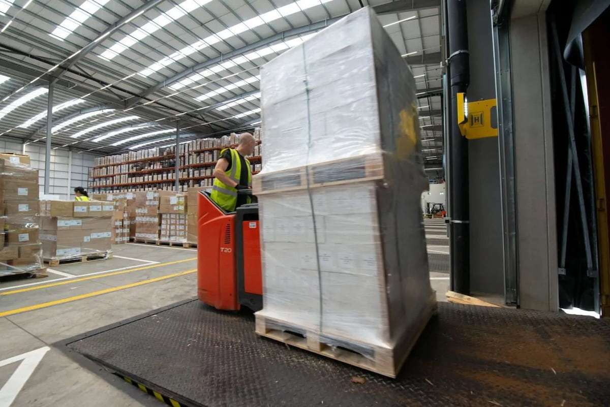 Someone lifting pallets in a warehouse