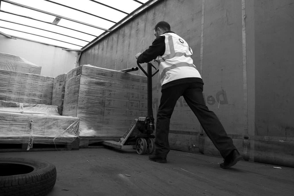 Someone loading pallets onto a truck