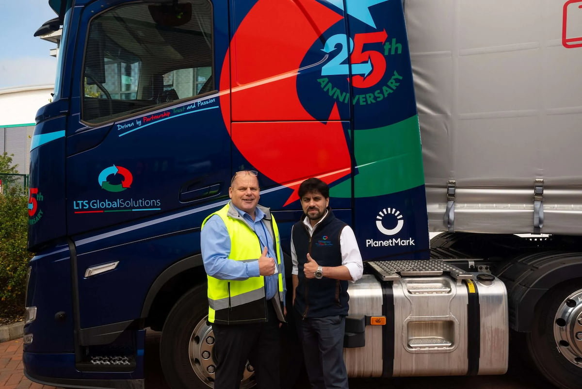 Two men stood in front of LTS truck with their thumbs up