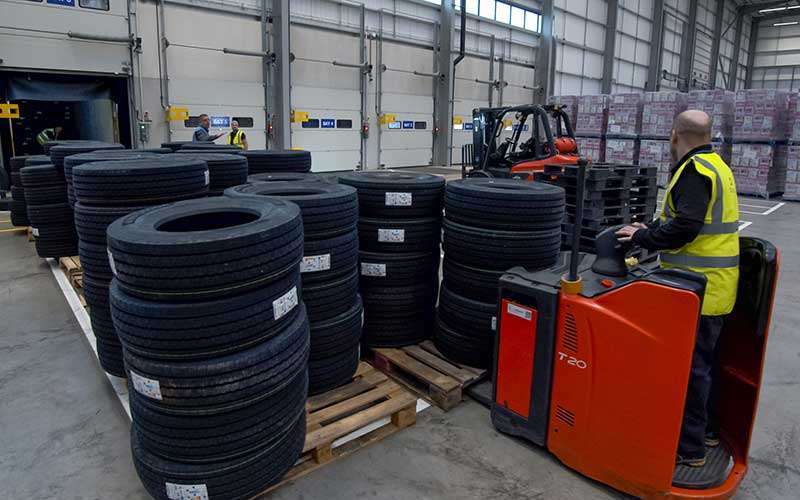 Image of tyres being unloaded from a container